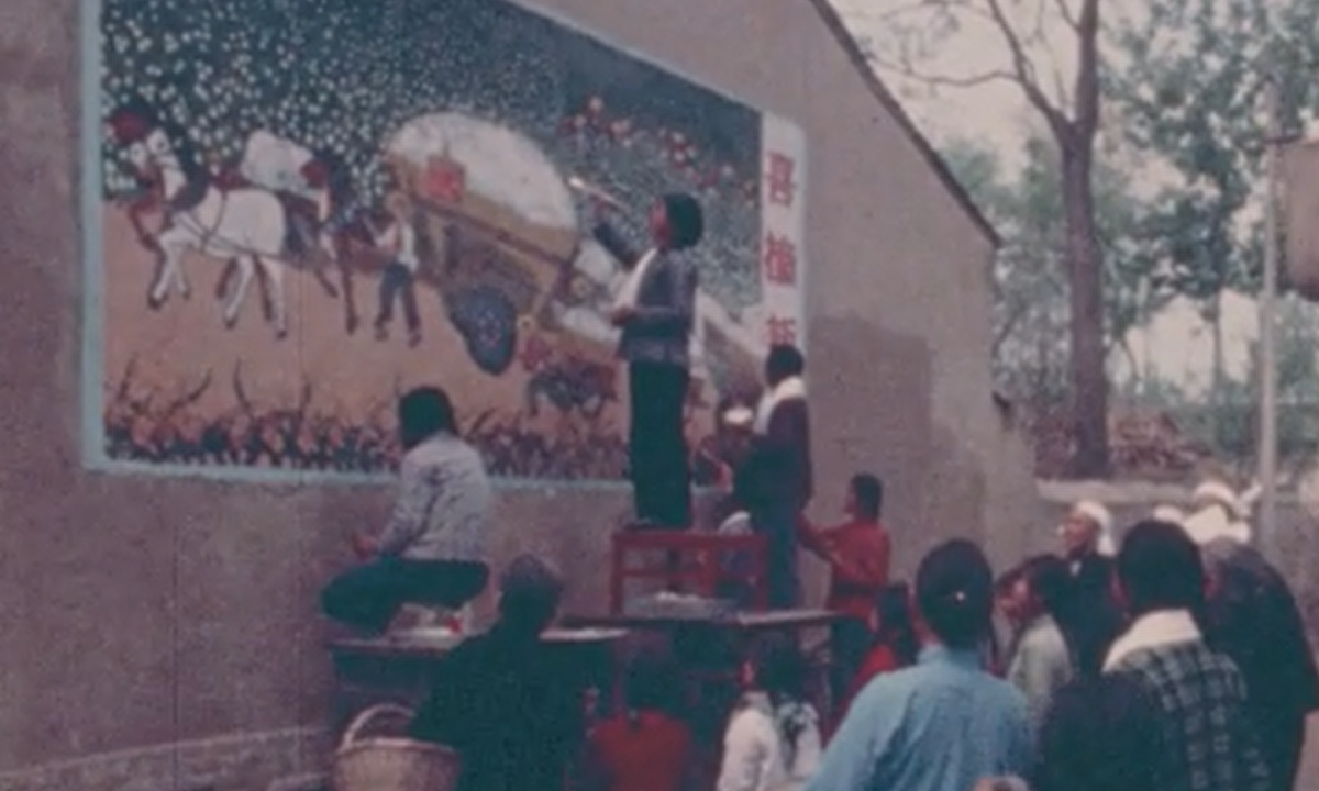 Woman standing on table painting a mural